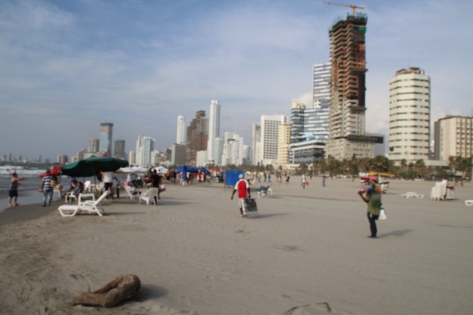 Beach by hotel with city in background